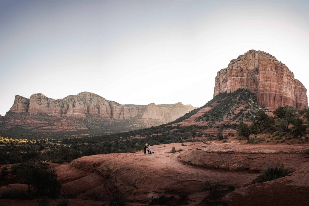 couple proposing in red rock of sedona, its a wide shot